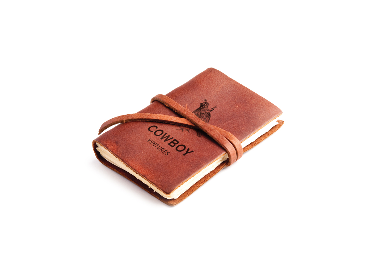 Cowboy Ventures branded notebook with an illustrated cowboy
